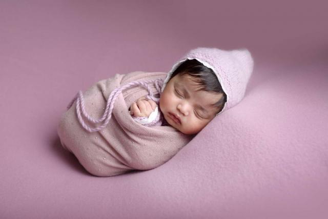 Newborn baby sleeps during the photo shoot in Frankfurt