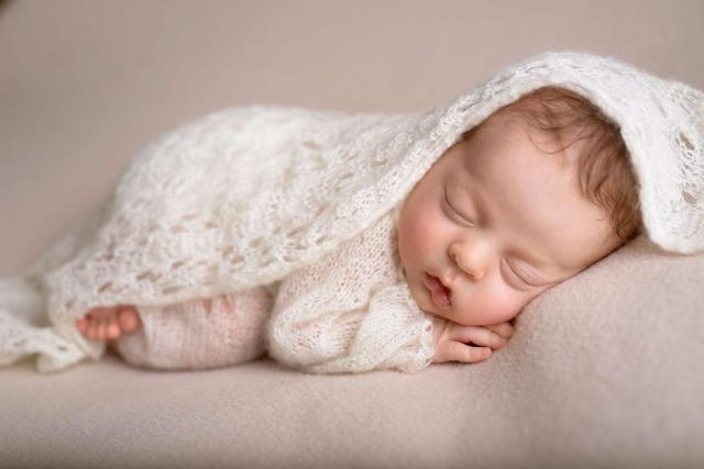 Sleeping newborn baby girl in pink